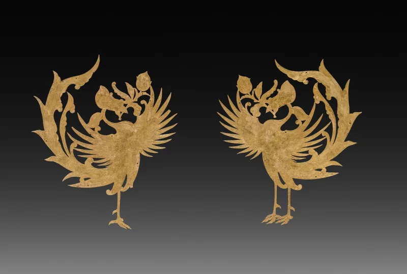 Pair of thin gold sheet ornaments, each cut with the profile of a phoenix and chased with feather detail