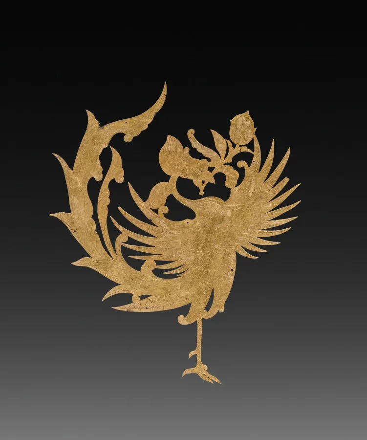 Thin gold sheet cut in the shape of a phoenix, with chased details on the surface