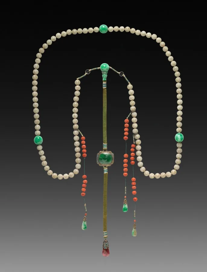 Court necklace of green jade beads alternating with coral, with spacer beads and a pendant strand