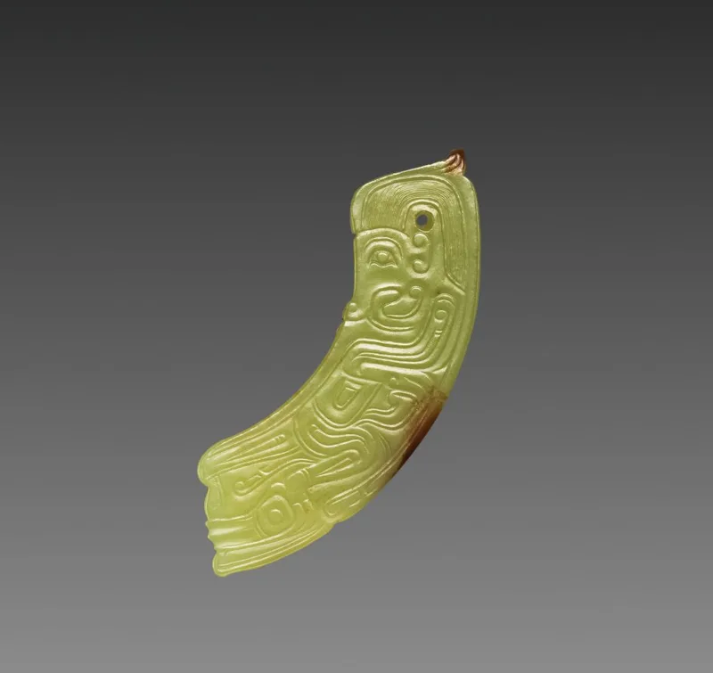 Arc-shaped nephrite pendant with a small human-like figure carved into the surface