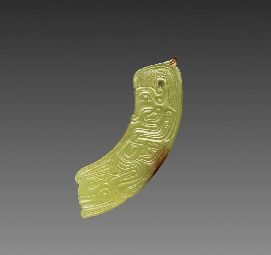 Arc-shaped nephrite pendant with a small human-like figure carved into the surface