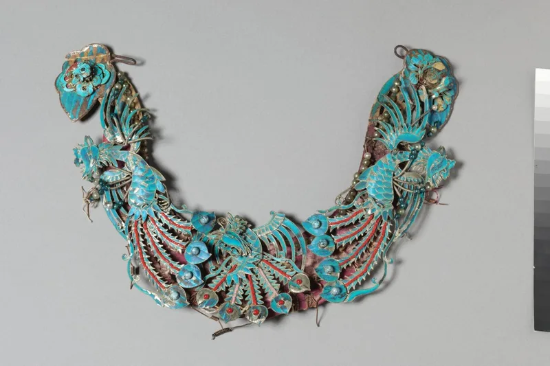 Group of eleven gilded silver headdress ornaments, each with a blue-green kingfisher-feather surface and glass-bead settings