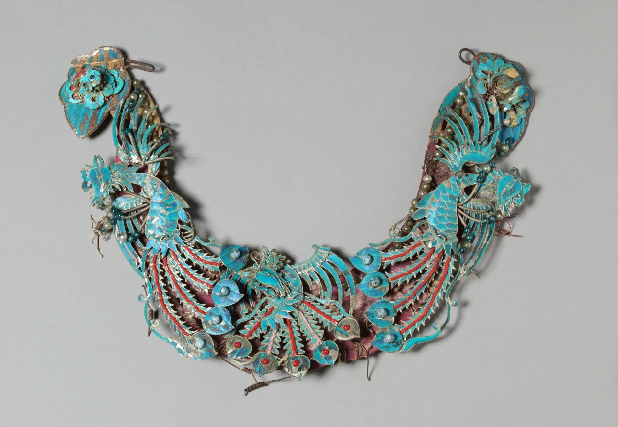 Gilded silver headdress element with blue kingfisher-feather inlay and glass beads