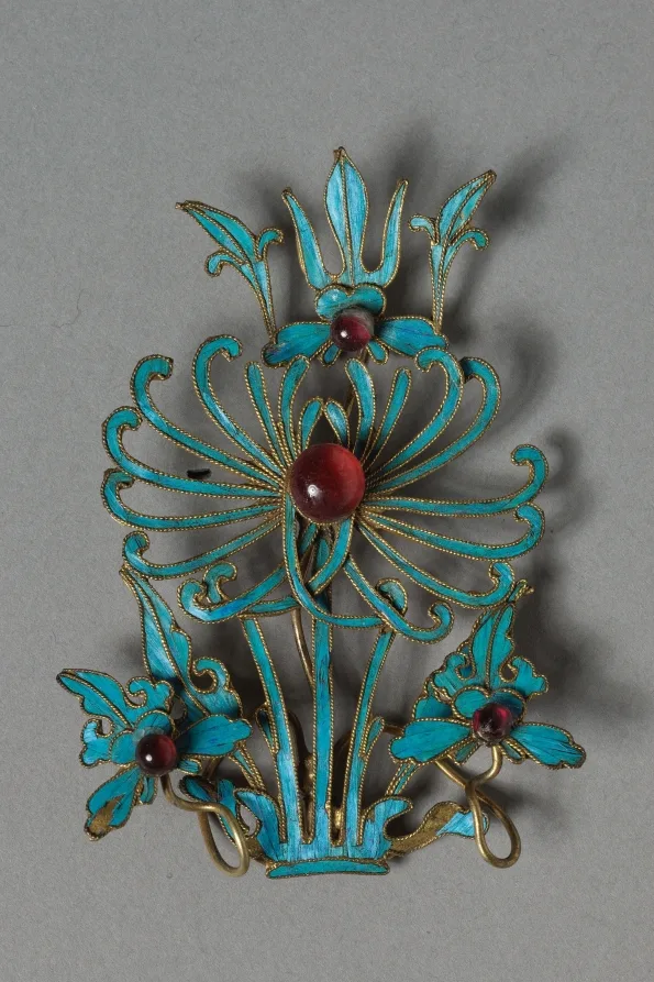 Gilded silver headdress ornament with turquoise-blue feather inlay and bead settings