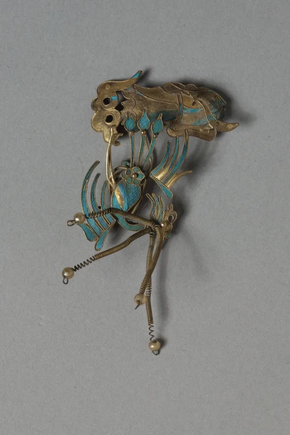 Gilded silver headdress element with blue-green feather inlay and small glass beads