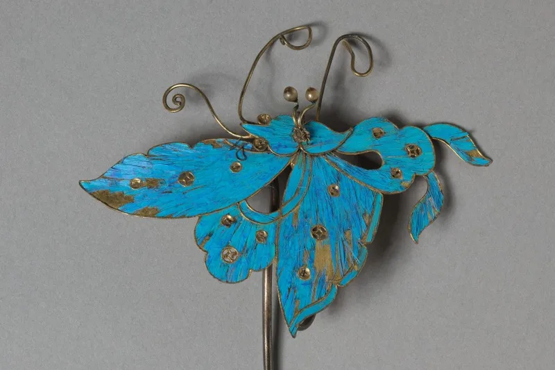 Gilded silver headdress element with turquoise feather inlay