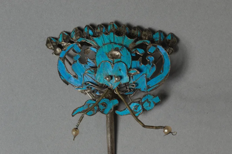 Gilded silver headdress ornament with blue feather inlay and beadwork