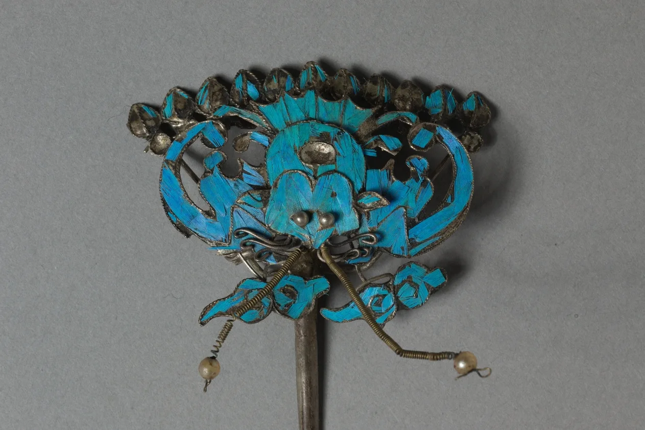 Gilded silver headdress ornament with blue feather inlay and beadwork