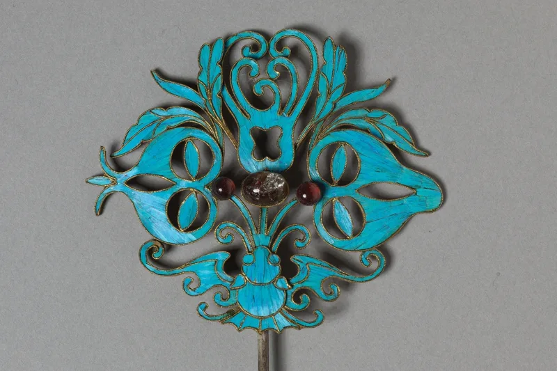 Gilded silver headdress element surfaced with kingfisher feathers