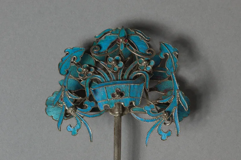 Gilded silver headdress element with turquoise feather surface and bead settings
