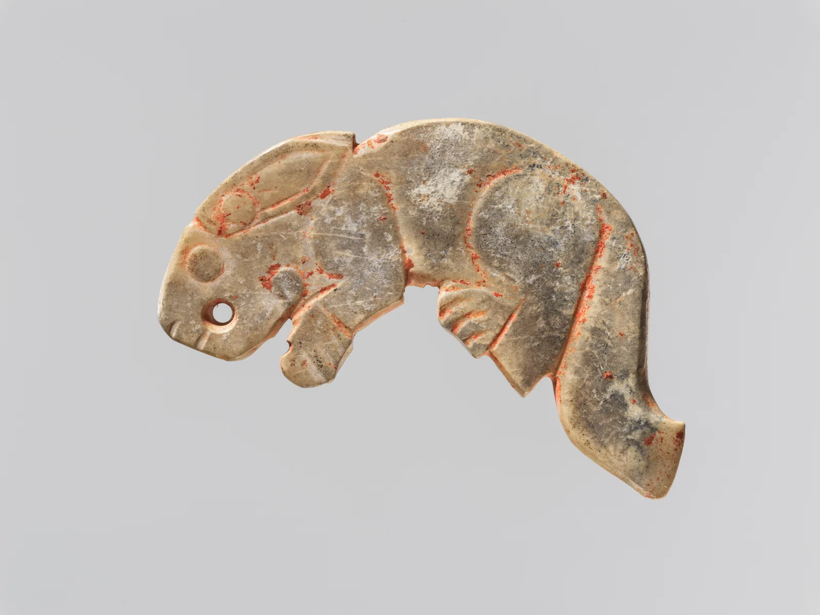 Jade (nephrite) pendant, plaque in the shape of a rabbit, shang and zhou dynasties, 2.5 cm high.