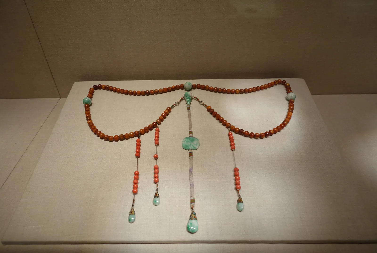 Jadeite, jade (nephrite), amber and coral necklace, qing dynasty, 104.1 cm long.
