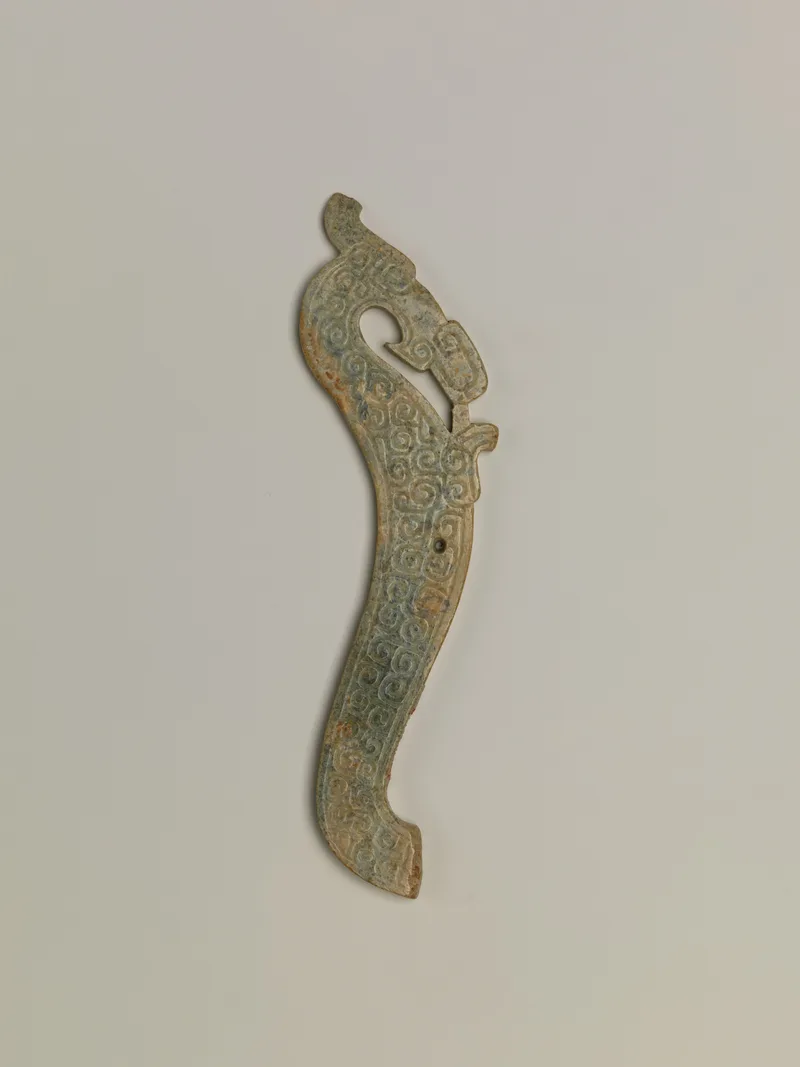 Jade (nephrite) pendant, in the shape of a crested dragon, shang and zhou dynasties, 10.8 cm wide.